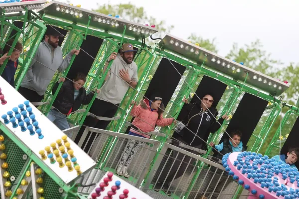 Families enjoying a midway ride at the Schomberg Fair